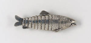 Silver coloured metal fish with moving lines of scales. Is a Jewish spice box.